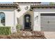 Charming home exterior with a decorative front door, manicured landscaping, and a two-car garage at 1377 Tappie Toorie Cir, Lake Mary, FL 32746