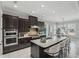 Spacious kitchen with a large granite island, modern stainless steel appliances, and ample cabinetry for culinary enthusiasts at 1377 Tappie Toorie Cir, Lake Mary, FL 32746