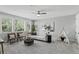 Neutral Living Room features light paint, a ceiling fan, and a view of mature landscaping at 1377 Tappie Toorie Cir, Lake Mary, FL 32746