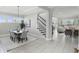 Open floor plan featuring dining area, staircase, and living room bathed in natural light at 1377 Tappie Toorie Cir, Lake Mary, FL 32746
