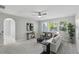 Neutral Living Room features light paint, a ceiling fan, and a view of mature landscaping at 1377 Tappie Toorie Cir, Lake Mary, FL 32746
