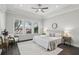 Bright main bedroom with tray ceiling, large windows, and dark wood flooring at 1377 Tappie Toorie Cir, Lake Mary, FL 32746