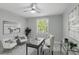 Bright office space with a ceiling fan, two armchairs, and a large window at 1377 Tappie Toorie Cir, Lake Mary, FL 32746