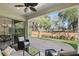 Relaxing covered patio with comfortable seating, ceiling fan, and a view of the serene backyard at 1377 Tappie Toorie Cir, Lake Mary, FL 32746