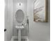 Clean powder room with an oval mirror and pedestal sink at 1377 Tappie Toorie Cir, Lake Mary, FL 32746