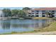 Scenic pond view with multi-story condo building at 13827 Fairway Island Dr # 1232, Orlando, FL 32837