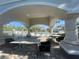 Poolside view from shaded area, complete with tables and lounge chairs at 13827 Fairway Island Dr # 1232, Orlando, FL 32837