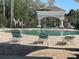 Relaxing pool area with lounge chairs and a covered gazebo at 13827 Fairway Island Dr # 1232, Orlando, FL 32837