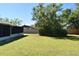 Spacious backyard with well-maintained lawn and trees, ideal for outdoor activities at 1389 Rural Hall St, Deltona, FL 32725