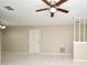 Bright living room with white tile flooring, neutral paint, and a ceiling fan at 1389 Rural Hall St, Deltona, FL 32725