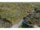 An aerial view showcases a lush, wooded lot on a quiet street at 140 Sweet Bay Cir, Lake Mary, FL 32746