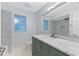 Updated bathroom featuring a green vanity, marble countertop, and a modern design at 140 Sweet Bay Cir, Lake Mary, FL 32746