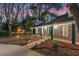 Attractive front exterior featuring a covered porch, brick facade, manicured landscaping, and driveway with landscape lighting at 140 Sweet Bay Cir, Lake Mary, FL 32746