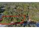 Aerial image showing the parcel of land outlined in red, surrounded by lush trees at 140 Sweet Bay Cir, Lake Mary, FL 32746