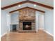 Cozy living room with a brick fireplace, wooden beams, and a built-in bar area with a wine fridge at 140 Sweet Bay Cir, Lake Mary, FL 32746