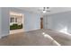 This light-filled main bedroom features plush carpet and connects to a bathroom with olive-green cabinetry at 140 Sweet Bay Cir, Lake Mary, FL 32746