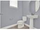 Powder room features a pedestal sink, mirror, and modern toilet at 14137 Walcott Ave, Orlando, FL 32827