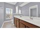 Bathroom features double sinks with modern fixtures, dark wood cabinets, a large mirror and ample counter space at 14137 Walcott Ave, Orlando, FL 32827