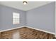 Bedroom featuring wood-look floors, neutral paint, and natural light, creating a relaxing space at 14137 Walcott Ave, Orlando, FL 32827