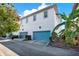 Two-story exterior view of townhome with manicured lawn and attached two-car garage at 14137 Walcott Ave, Orlando, FL 32827