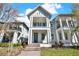 Charming two-story home featuring a balcony, blue door, steps to entrance, and manicured lawn at 14137 Walcott Ave, Orlando, FL 32827