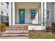 Inviting front porch with brick steps, blue door, and manicured landscaping at 14137 Walcott Ave, Orlando, FL 32827