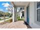 Inviting front porch with brick steps, blue door, and view of the neighborhood at 14137 Walcott Ave, Orlando, FL 32827