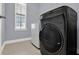 Modern laundry room with front-loading machines and large window for natural light at 14137 Walcott Ave, Orlando, FL 32827