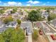 Residential neighborhood featuring a charming home with a gray roof and mature trees at 150 Chicago Woods Cir, Orlando, FL 32824