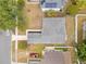 Birds eye view of a home with gray roof and a well maintained yard, plus a red car in the driveway at 150 Chicago Woods Cir, Orlando, FL 32824