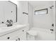 Bathroom featuring modern fixtures including a black framed mirror, sink, toilet and bathtub at 150 Chicago Woods Cir, Orlando, FL 32824