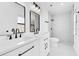 Modern bathroom featuring double vanity, sleek fixtures, and walk-in shower, combining functionality with contemporary design at 150 Chicago Woods Cir, Orlando, FL 32824