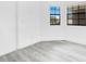 Serene bedroom features wood-look floors, bright windows, and minimalist decor, offering a peaceful retreat at 150 Chicago Woods Cir, Orlando, FL 32824