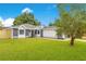 Charming single-story home featuring a lush green lawn, gray brick accents, and a well-maintained gray roof at 150 Chicago Woods Cir, Orlando, FL 32824