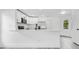 Bright kitchen with white cabinets, stainless steel appliances, a breakfast bar, and easy access to the dining area at 150 Chicago Woods Cir, Orlando, FL 32824