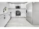 Modern kitchen with stainless steel appliances, white cabinets, and sleek countertops, offering both style and functionality at 150 Chicago Woods Cir, Orlando, FL 32824