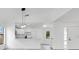 Open-concept living area with a view of a modern kitchen and bright and airy open spaces at 150 Chicago Woods Cir, Orlando, FL 32824