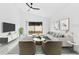 Bright living room with modern furniture, a large window, and a ceiling fan, creating a relaxing atmosphere at 150 Chicago Woods Cir, Orlando, FL 32824