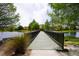 Scenic view of a bridge over a lake, surrounded by lush greenery and community homes at 155 Barefoot Beach Way, Kissimmee, FL 34746