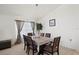 Bright dining room with modern light fixture and comfortable seating at 155 Barefoot Beach Way, Kissimmee, FL 34746