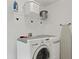 Clean laundry room with modern washer and dryer at 155 Barefoot Beach Way, Kissimmee, FL 34746