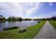 Picturesque pond in the neighborhood, with a walking path and fountain at 155 Barefoot Beach Way, Kissimmee, FL 34746