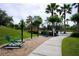 Community recreation area featuring exercise equipment, a walking path, and palm trees at 155 Barefoot Beach Way, Kissimmee, FL 34746