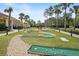 A community miniature golf course surrounded by mature trees and landscaping at 155 Barefoot Beach Way, Kissimmee, FL 34746