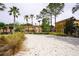 Sandy volleyball court surrounded by lush landscaping and palm trees provides a relaxing recreational area at 155 Barefoot Beach Way, Kissimmee, FL 34746