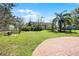 Backyard with a green lawn and brick patio, perfect for outdoor activities at 1613 N Lakewood Ave, Ocoee, FL 34761