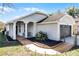 Charming single story home with a two car garage, arched covered porch and updated landscaping at 1613 N Lakewood Ave, Ocoee, FL 34761