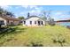 View of the exterior of the home with lawn and patio at 1613 N Lakewood Ave, Ocoee, FL 34761