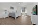 Bright bedroom featuring a white frame bed, matching nightstands and a large screen TV at 17572 Davenport Rd, Winter Garden, FL 34787