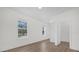 Sunlit bedroom with hardwood floors, ensuite bathroom, and views of the backyard at 17572 Davenport Rd, Winter Garden, FL 34787